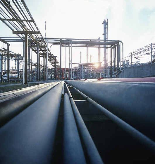 Metal pipes and equipment in an oil refinery.