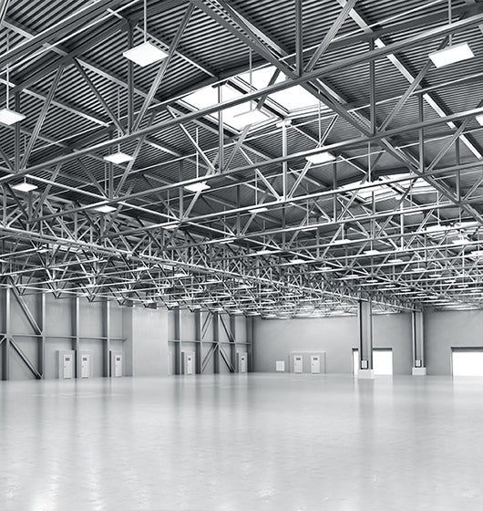Spacious warehouse with high metal ceiling.